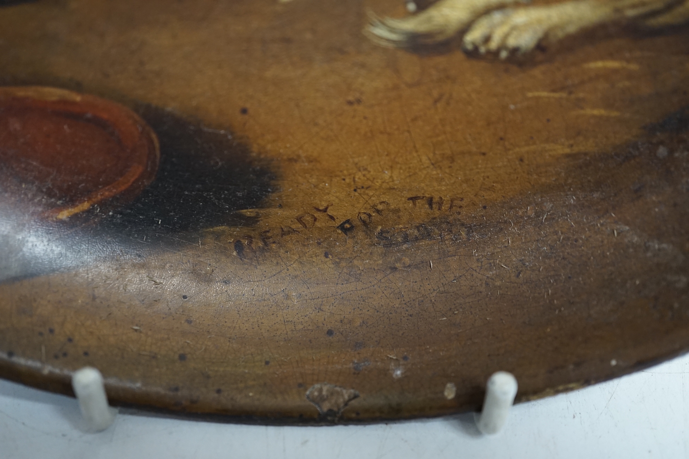 A late 19th century painted papier mache dish, Ready for the Sport, decorated with seated spaniels, 21cm